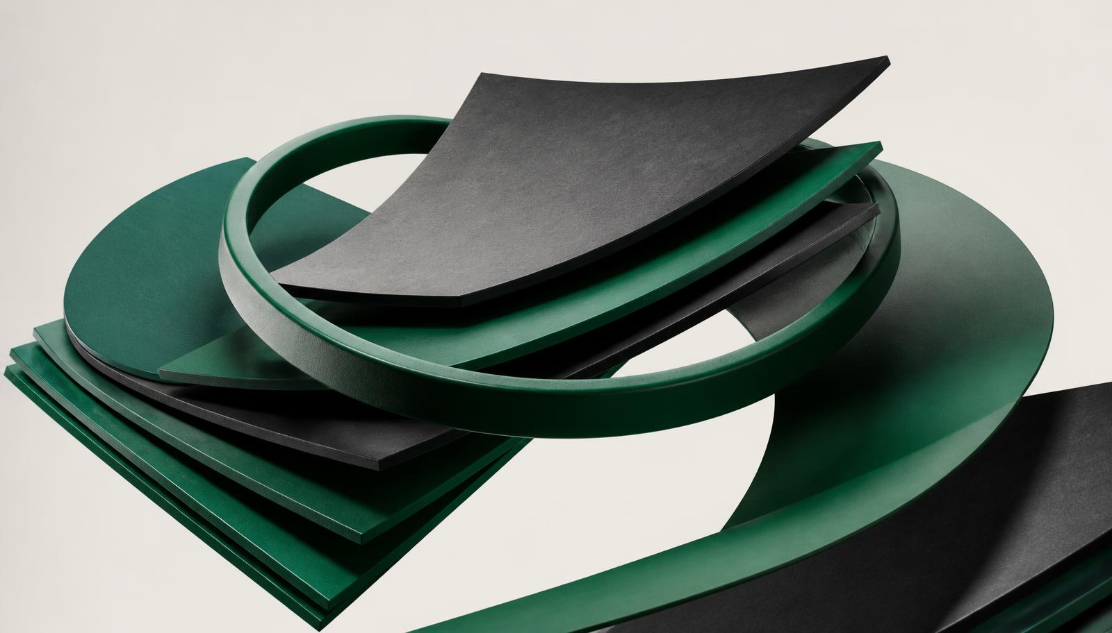 Emerald green and graphite layered sheets orbiting a circular ring